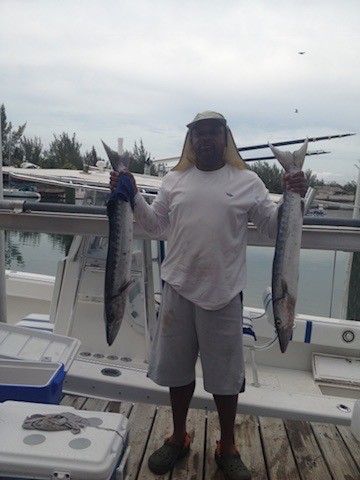 Ty holding two catches at the dock